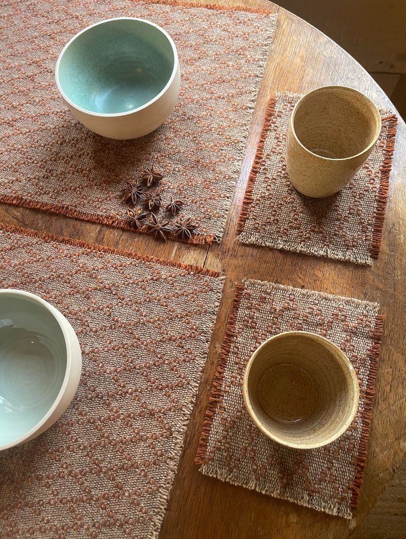 Experimenting with woven placemats and coasters, featuring Karen Tacey ceramics.
