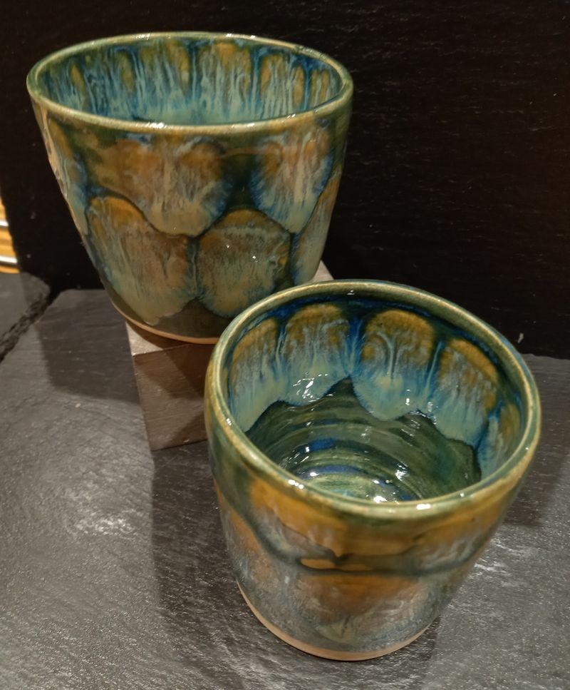 Two green toned beakers